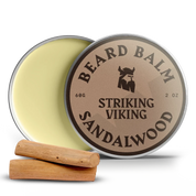 Sandalwood beard balm tin with lid open, two wood pieces beside.