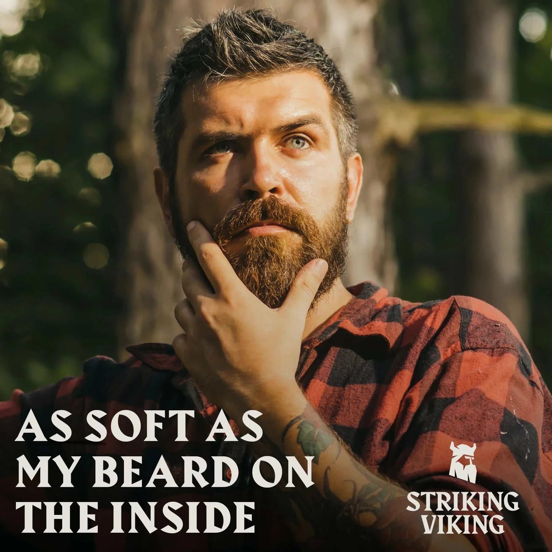Bearded man outdoors applying Striking Viking Beard Oil, promoting softness and citrus scent.