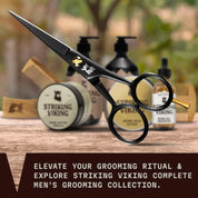 Beard and mustache scissors with Striking Viking branding, displayed alongside grooming products and a comb.