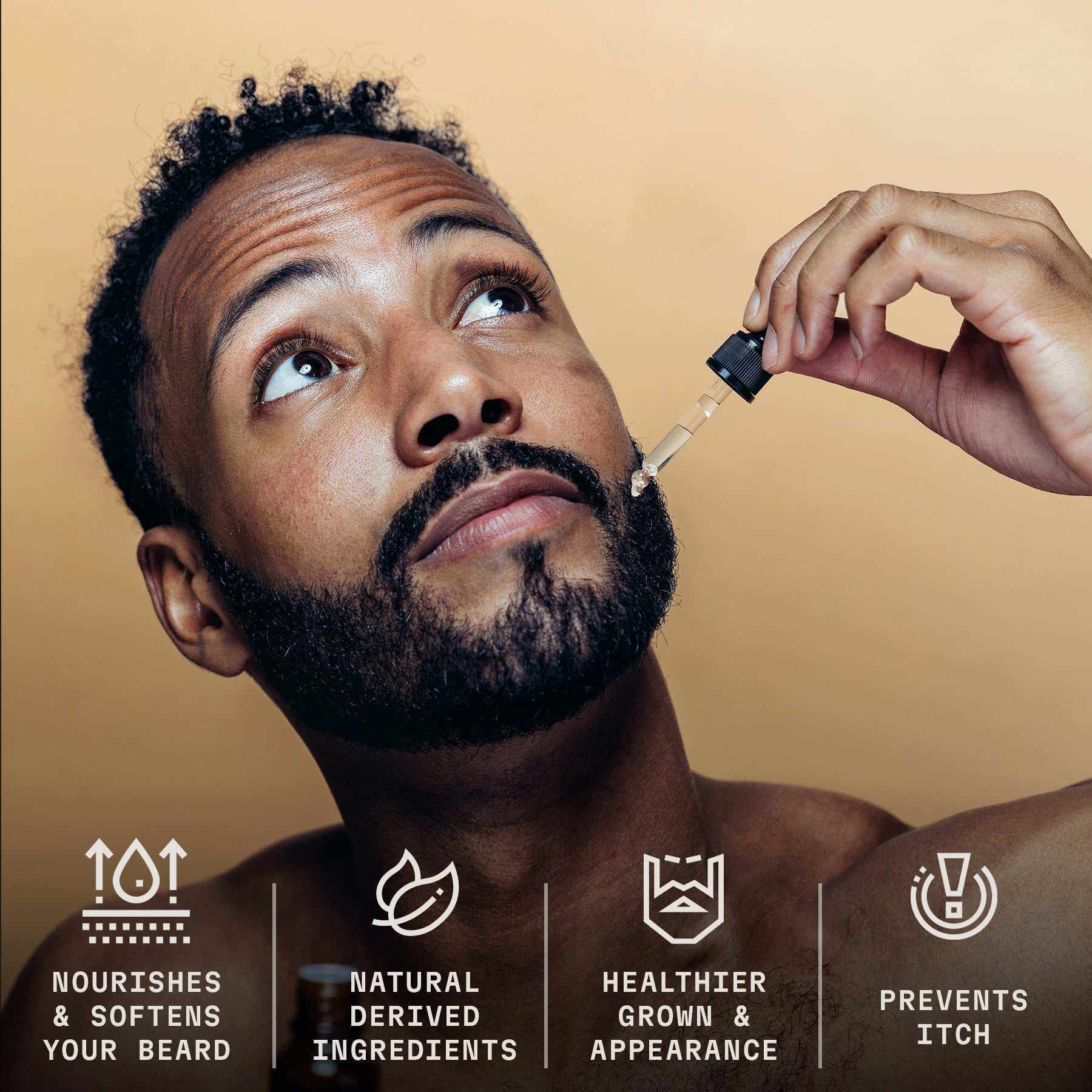 Bearded man using dropper to apply sandalwood beard oil, promotes healthy and soft beard care.